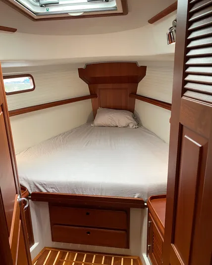 Salacia Yacht Photos Pics Cozy cabin interior of 2016 Blue Jacket 40 sailboat with wooden finish and bed.