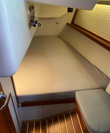 Salacia Yacht Photos Pics Cozy cabin interior of 2016 Blue Jacket 40 sailboat with wooden accents and comfortable bedding.