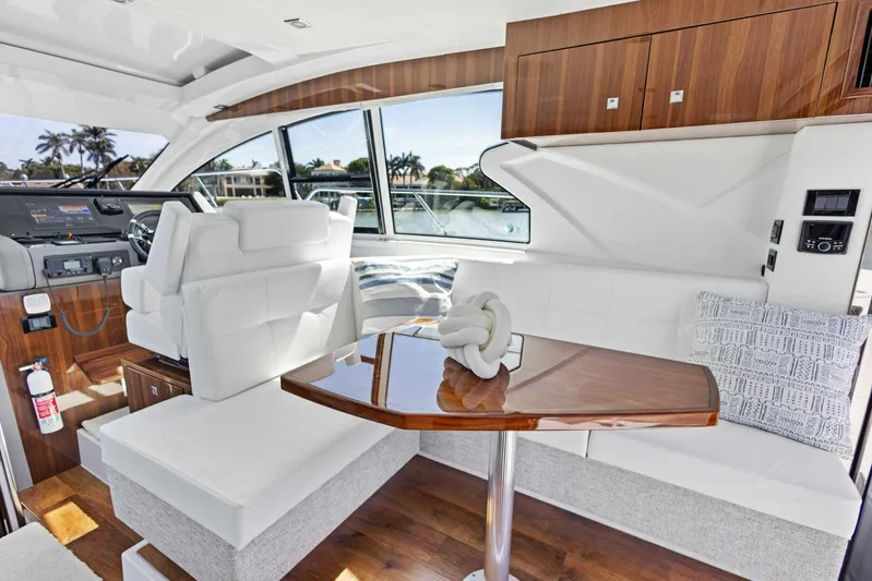 Bradventures Yacht Photos Pics Luxurious interior of 2023 Cruisers Yachts 42 Cantius with elegant seating and wooden accents.