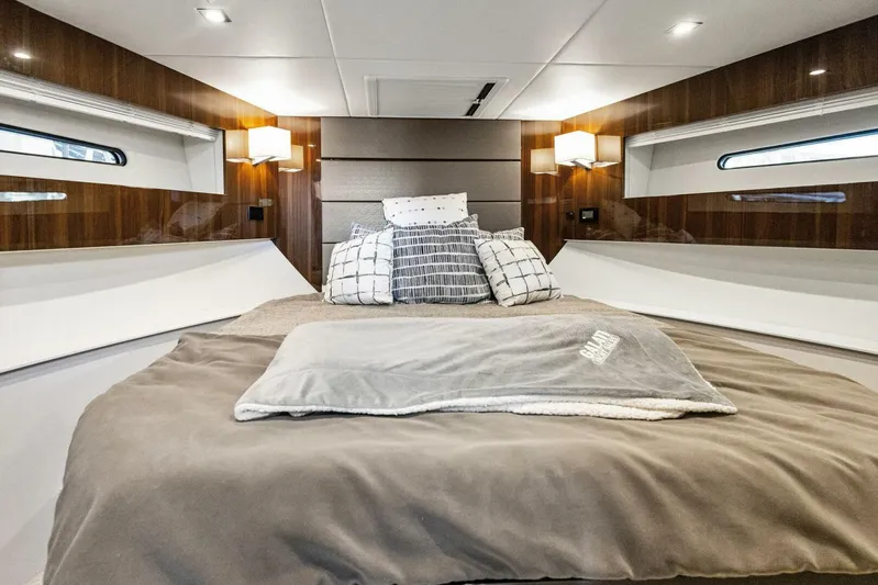 Bradventures Yacht Photos Pics Luxurious bedroom interior of 2023 Cruisers Yachts 42 Cantius with modern design and cozy bedding.
