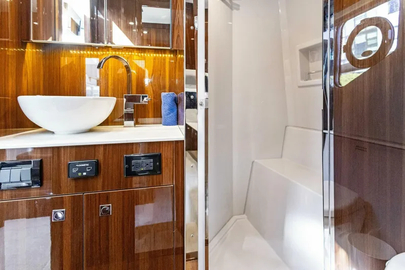 Bradventures Yacht Photos Pics Luxurious bathroom interior of 2023 Cruisers Yachts 42 Cantius with modern fixtures.