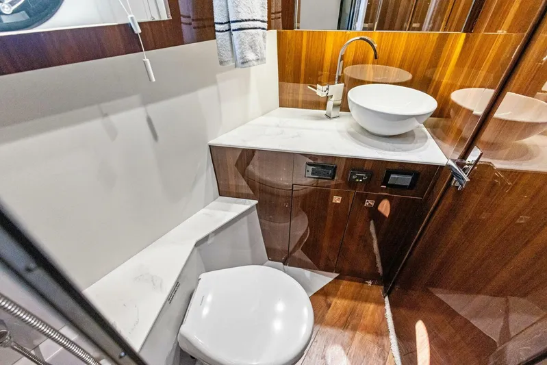 Bradventures Yacht Photos Pics 2023 Cruisers Yachts 42 Cantius bathroom with modern sink and wooden cabinetry.