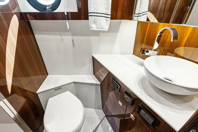 Bradventures Yacht Photos Pics Luxurious bathroom in 2023 Cruisers Yachts 42 Cantius, featuring modern sink and elegant wood finishes.