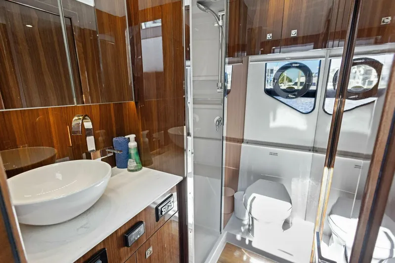 Bradventures Yacht Photos Pics Luxurious bathroom in 2023 Cruisers Yachts 42 Cantius with modern fixtures and wood accents.