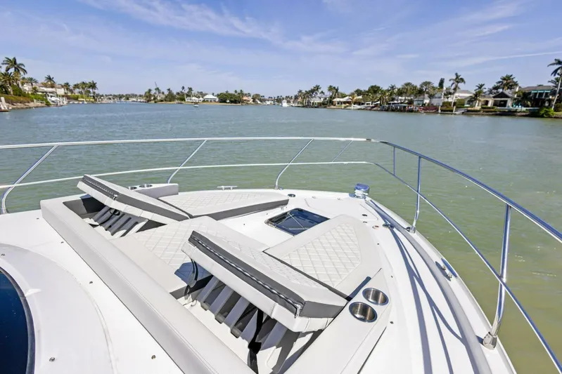 Bradventures Yacht Photos Pics 2023 Cruisers Yachts 42 Cantius deck with sun loungers overlooking serene waterway.