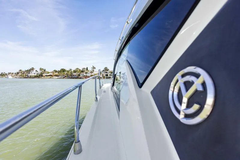 Bradventures Yacht Photos Pics 2023 Cruisers Yachts 42 Cantius on water, side view with logo, scenic background.