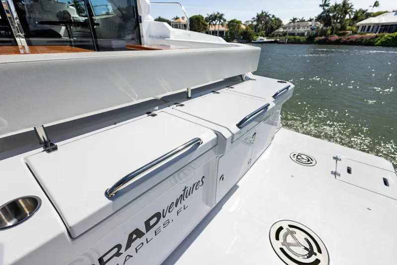 Bradventures Yacht Photos Pics 2023 Cruisers Yachts 42 Cantius on a sunny waterfront, showcasing sleek design and luxury features.