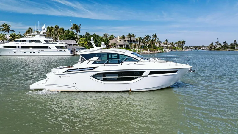 Bradventures Yacht Photos Pics 2023 Cruisers Yachts 42 Cantius on serene water with palm trees in the background.