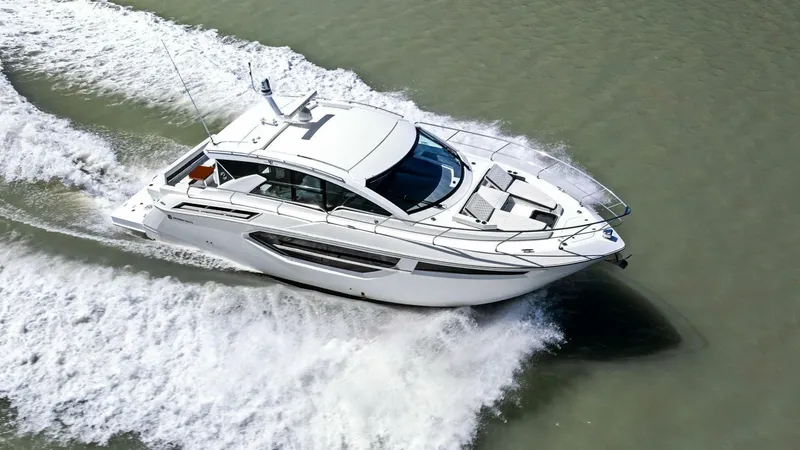 Bradventures Yacht Photos Pics 2023 Cruisers Yachts 42 Cantius cruising on water, aerial view.