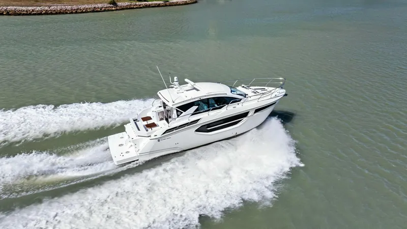 Bradventures Yacht Photos Pics 2023 Cruisers Yachts 42 Cantius cruising on open water, aerial view.