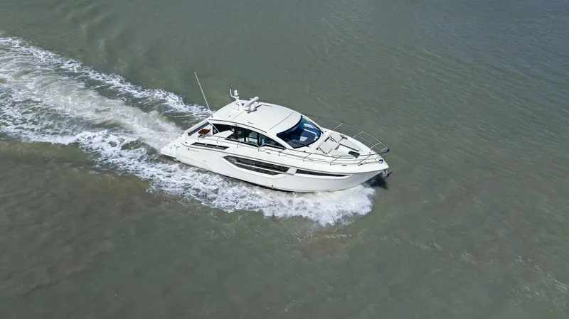 Bradventures Yacht Photos Pics 2023 Cruisers Yachts 42 Cantius cruising on open water, aerial view.