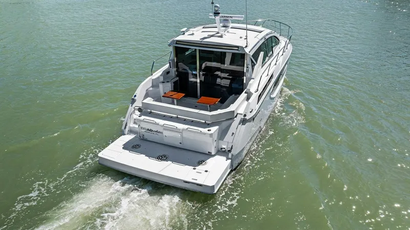 Bradventures Yacht Photos Pics 2023 Cruisers Yachts 42 Cantius cruising on open water, rear view.