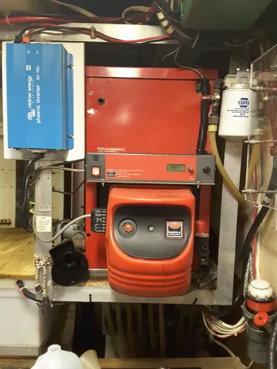 Orina Yacht Photos Pics Engine room of 1971 Southern Marine MALAHIDE Pilothouse LRC with red machinery and wiring.