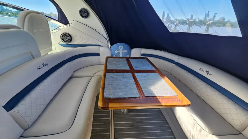  Yacht Photos Pics Luxurious interior of 2005 Sea Ray 390 Sundancer yacht with elegant seating and table.