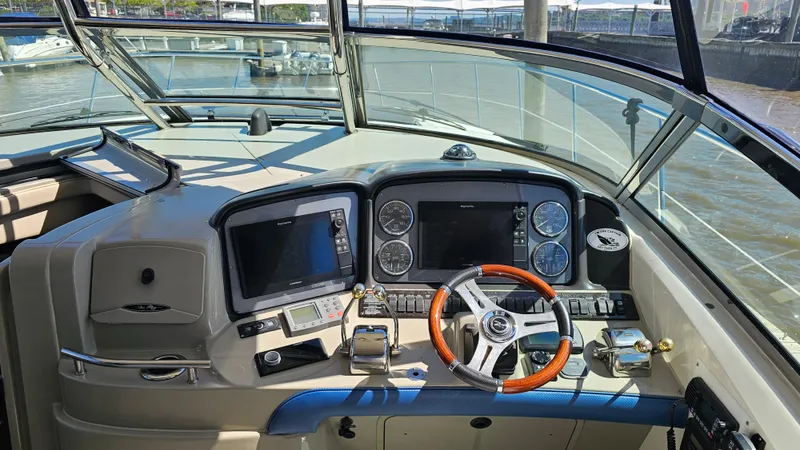  Yacht Photos Pics 2005 Sea Ray 390 Sundancer helm with modern navigation equipment and wooden steering wheel.