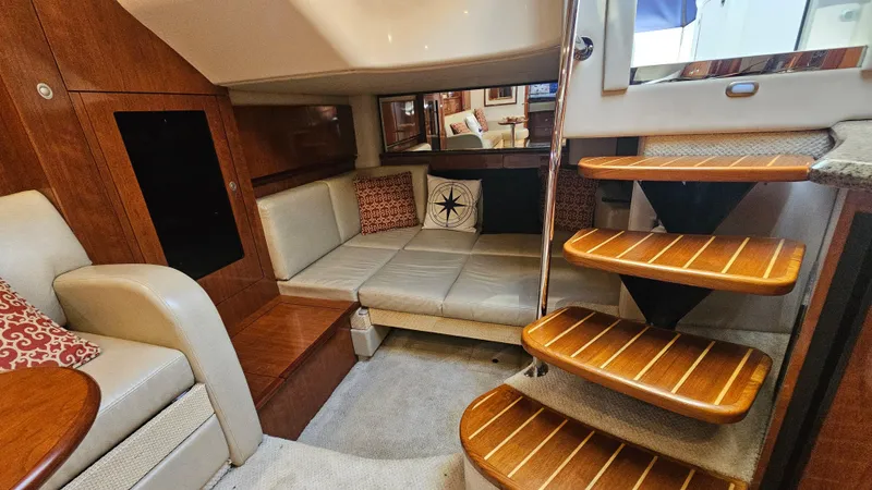  Yacht Photos Pics 2005 Sea Ray 390 Sundancer interior with cozy seating and wooden steps.