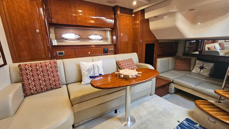  Yacht Photos Pics Luxurious 2005 Sea Ray 390 Sundancer interior with elegant seating and wooden accents.