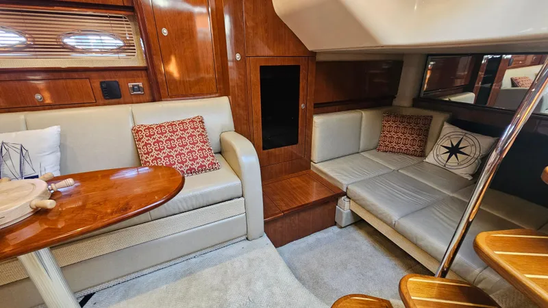  Yacht Photos Pics Interior of 2005 Sea Ray 390 Sundancer with beige seating and wooden accents.