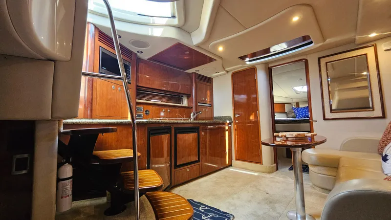  Yacht Photos Pics Luxurious interior of a 2005 Sea Ray 390 Sundancer yacht with wood cabinetry and seating.