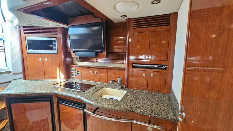  Yacht Photos Pics Luxurious 2005 Sea Ray 390 Sundancer yacht kitchen with wood cabinetry and modern appliances.