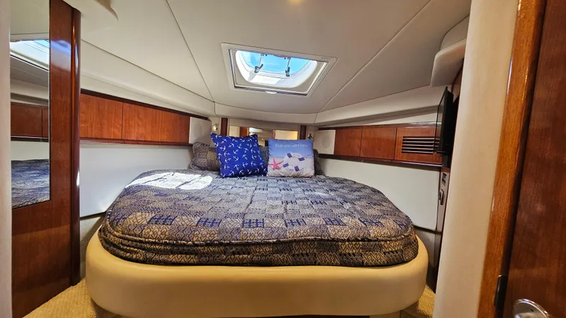  Yacht Photos Pics Luxurious cabin interior of 2005 Sea Ray 390 Sundancer yacht with skylight and cozy bedding.