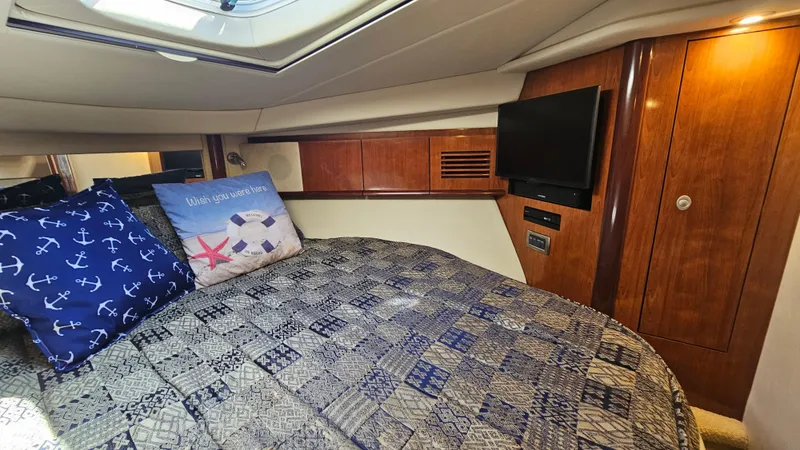  Yacht Photos Pics Luxurious cabin interior of 2005 Sea Ray 390 Sundancer with cozy bedding and TV.