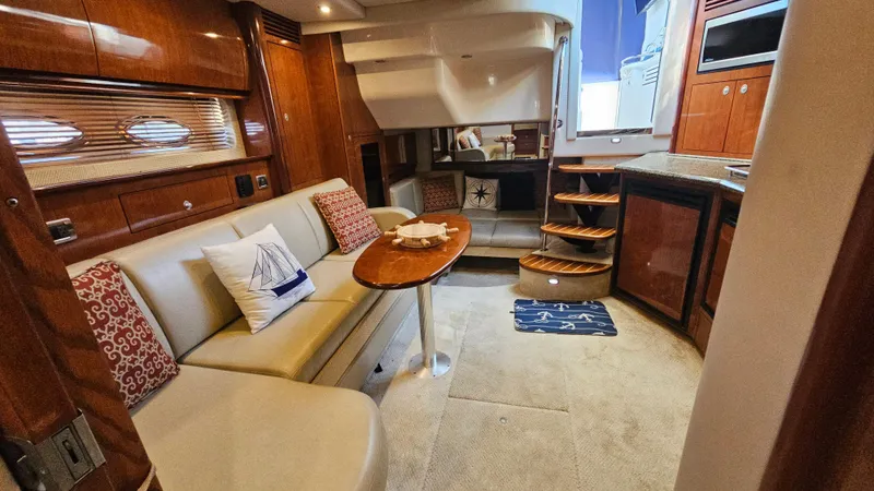  Yacht Photos Pics Luxurious interior of 2005 Sea Ray 390 Sundancer yacht with elegant seating and wooden finishes.