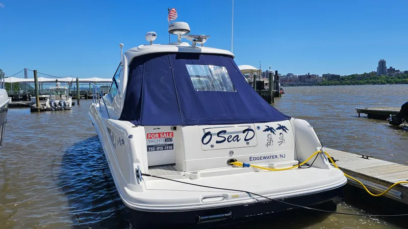  Yacht Photos Pics 2005 Sea Ray 390 Sundancer yacht docked, featuring a blue canopy and "For Sale" sign.