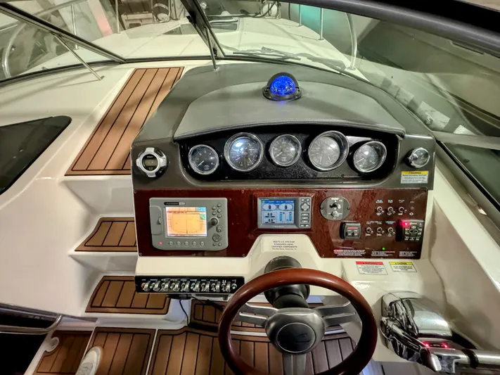 Josh'd Yacht Photos Pics Dashboard of 2010 Sea Ray Sundancer 310 with wood paneling.