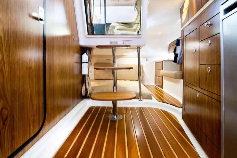Let&rsquo;s Go II Yacht Photos Pics Interior of 2013 Pursuit OS 345 Offshore boat with wood paneling and modern amenities.