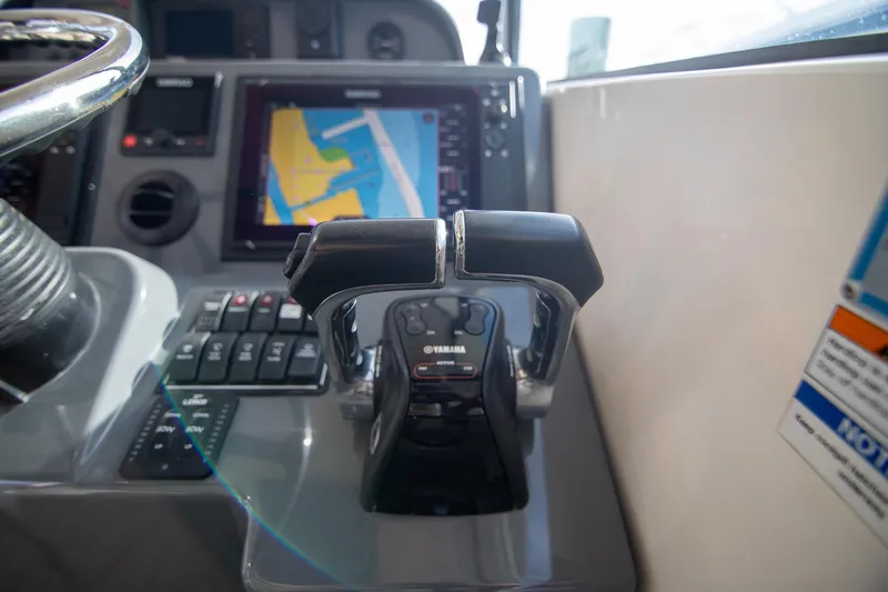 Let&rsquo;s Go II Yacht Photos Pics Control panel of 2013 Pursuit OS 345 Offshore boat with navigation screen and throttle.