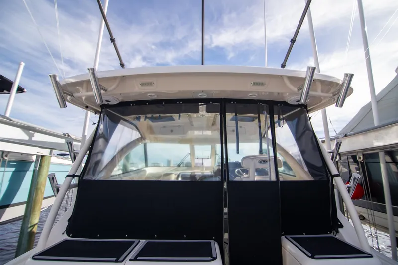 Let&rsquo;s Go II Yacht Photos Pics 2013 Pursuit OS 345 Offshore boat with covered cockpit and fishing rod holders.