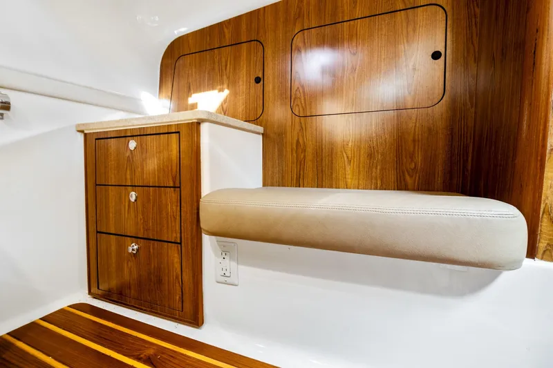 Let&rsquo;s Go II Yacht Photos Pics Interior of 2013 Pursuit OS 345 Offshore boat with wood cabinetry and cushioned seating.