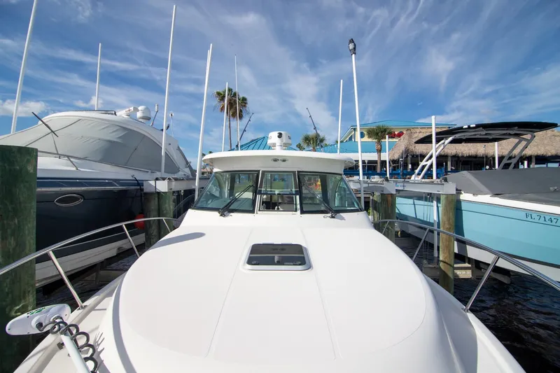 Let&rsquo;s Go II Yacht Photos Pics 2013 Pursuit OS 345 Offshore boat docked at marina under blue sky.