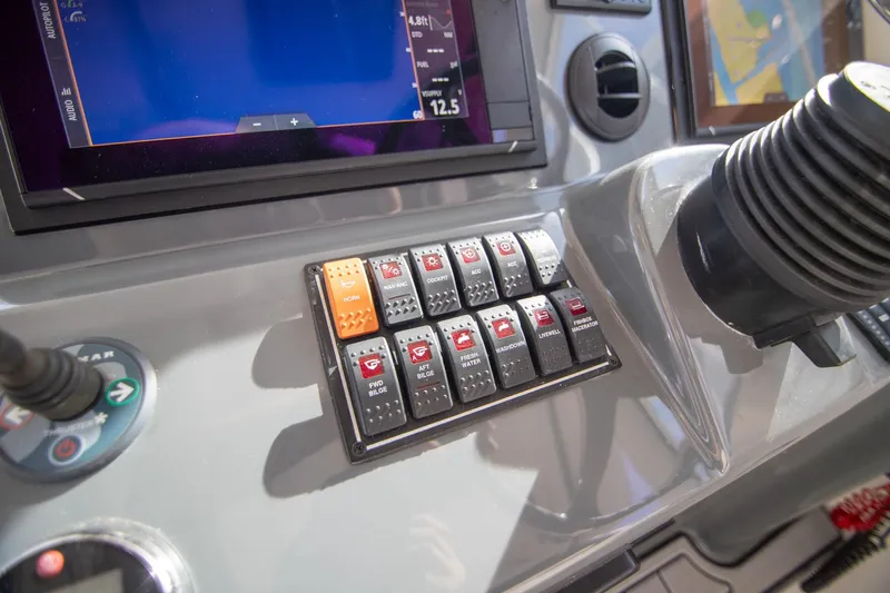 Let&rsquo;s Go II Yacht Photos Pics Control panel of a 2013 Pursuit OS 345 Offshore boat with switches and displays.