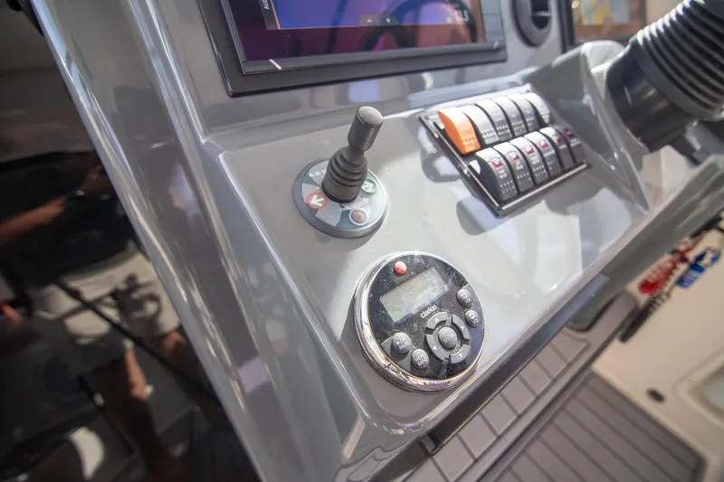 Let&rsquo;s Go II Yacht Photos Pics Control panel of a 2013 Pursuit OS 345 Offshore boat with joystick and switches.