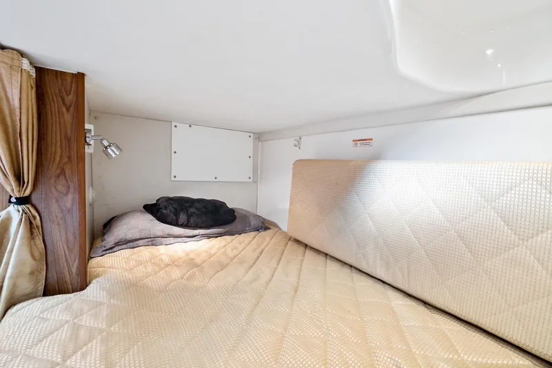 Let&rsquo;s Go II Yacht Photos Pics Cozy cabin interior of 2013 Pursuit OS 345 Offshore boat with bed and reading light.