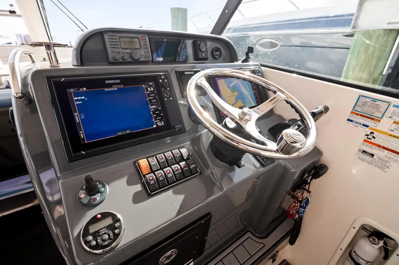 Let&rsquo;s Go II Yacht Photos Pics 2013 Pursuit OS 345 Offshore boat dashboard with navigation controls and steering wheel.