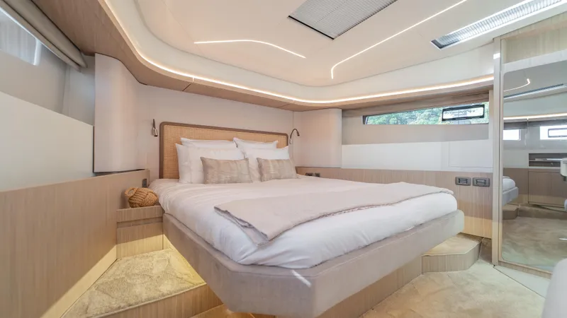  Yacht Photos Pics Luxurious bedroom interior on 2025 Prestige F4.9 yacht, featuring modern design and ambient lighting.
