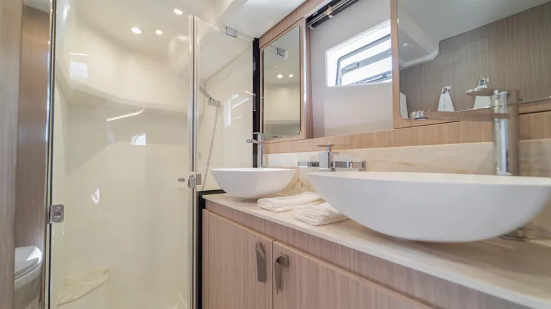  Yacht Photos Pics Luxurious bathroom in 2025 Prestige F4.9 yacht with dual sinks and modern shower.