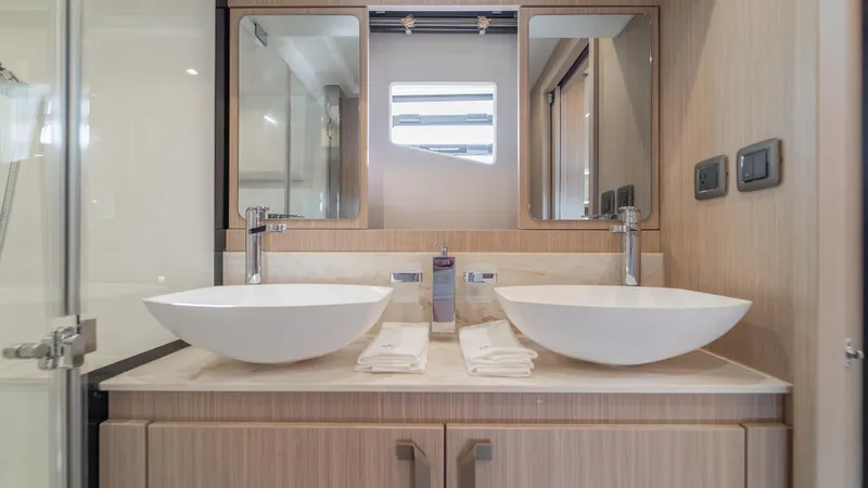  Yacht Photos Pics Modern bathroom with dual sinks in a 2025 Prestige F4.9 model yacht.