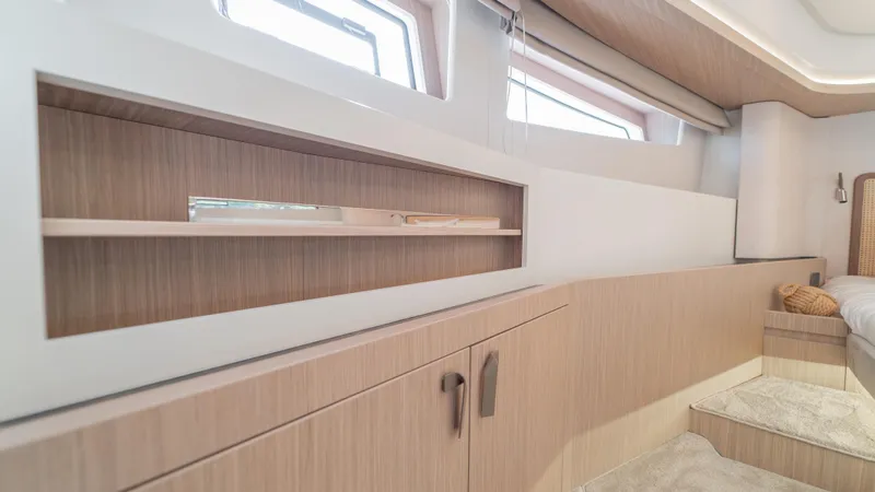  Yacht Photos Pics Luxurious interior of 2025 Prestige F4.9 yacht with modern wood cabinetry and windows.