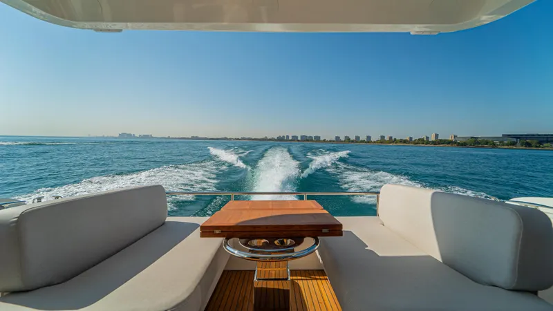  Yacht Photos Pics Luxury yacht Prestige F4.9, 2025 model, cruising on open water with city skyline view.