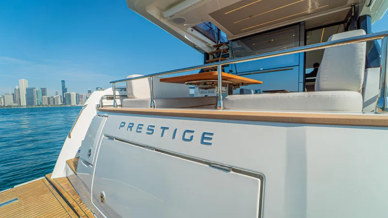  Yacht Photos Pics Luxury Prestige F4.9 yacht, 2025 model, docked with city skyline in background.