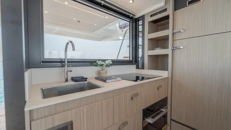  Yacht Photos Pics Modern kitchen interior on a 2025 Prestige F4.9 yacht, featuring sleek cabinetry and appliances.
