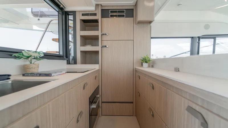  Yacht Photos Pics Modern kitchen interior of 2025 Prestige F4.9 yacht with sleek cabinetry and appliances.