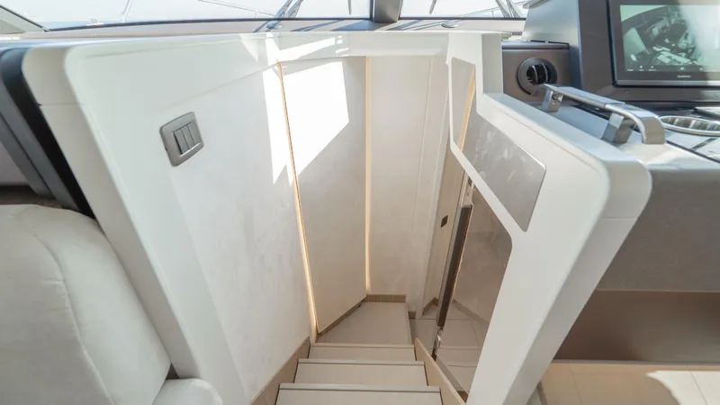  Yacht Photos Pics Staircase leading below deck on 2025 Prestige F4.9 yacht, featuring modern design and lighting.