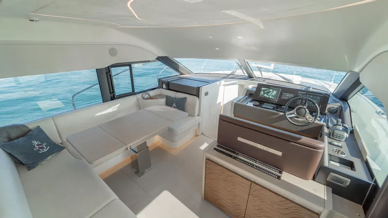  Yacht Photos Pics Luxurious interior of 2025 Prestige F4.9 yacht with modern helm and seating area.