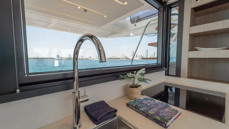  Yacht Photos Pics Modern kitchen interior on Prestige F4.9 yacht, featuring sleek faucet, ocean view, and decor.