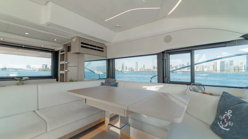  Yacht Photos Pics Luxurious interior of 2025 Prestige F4.9 yacht with panoramic windows and elegant seating.